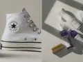 Weiße Converse und Pflegeprodukte für sneakers reinigen. Ein Set mit Bürste, Schaumreiniger und Imprägnierspray.
