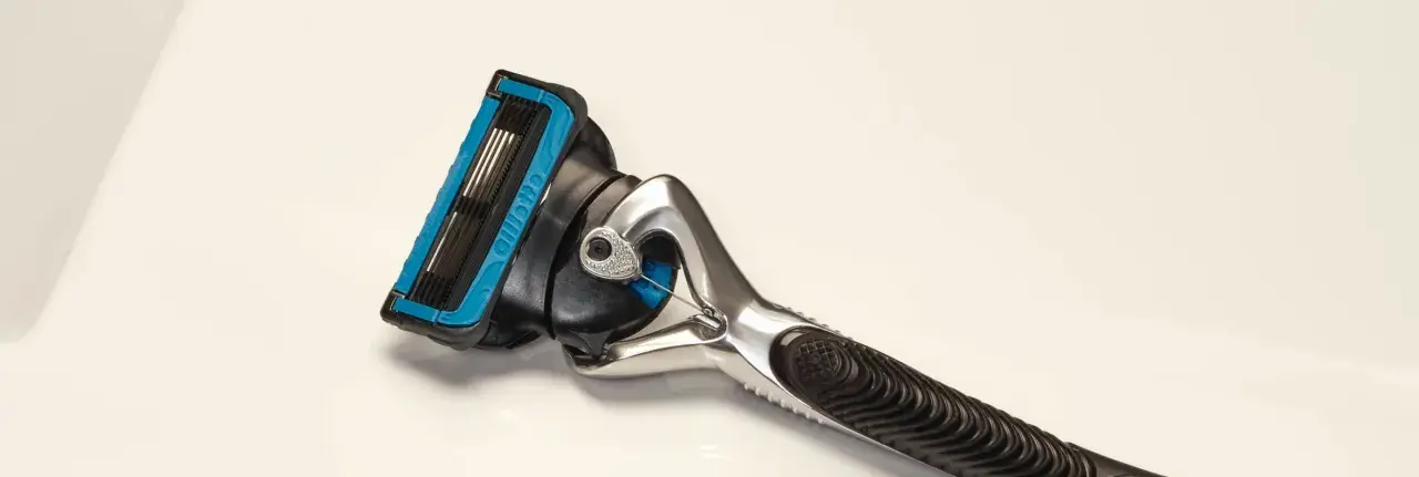Ein Rasierer mit blauer Kappe und mehreren Klingen. Die Rasierklingen reinigen sanft die Haut für eine glatte Rasur.